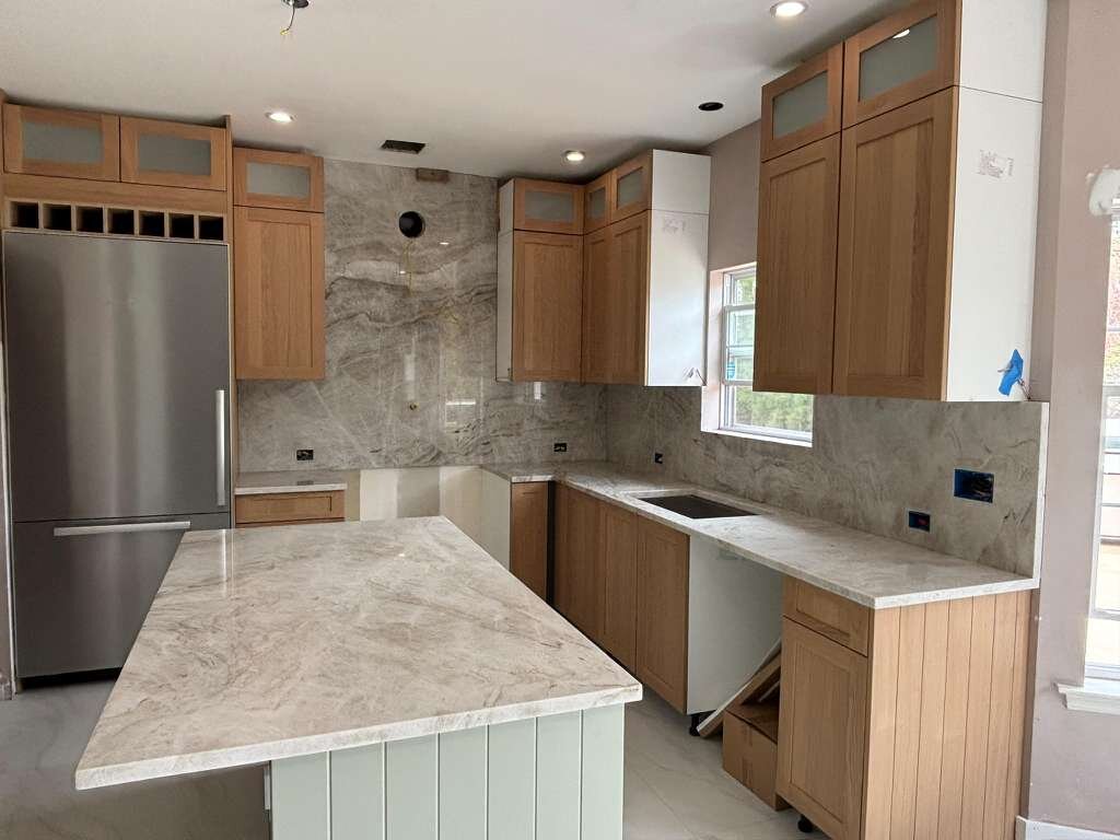 Crafted natural oak kitchen cabinetry and stone countertops