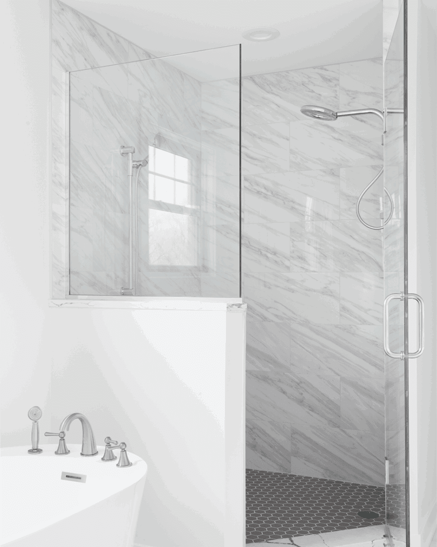 Luxurious marble-tiled shower and bathtub